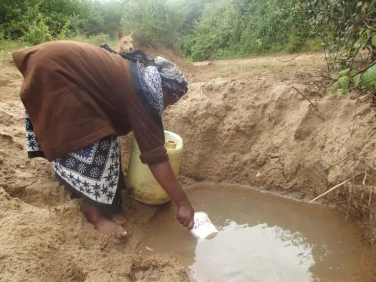 Une femme va chercher de l'eau dans une scoophole au Kenya. Les problèmes d'eau en Afrique continuent d'être un problème majeur.