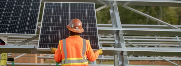 Worker installing solar panel at Coldwater Solar plant